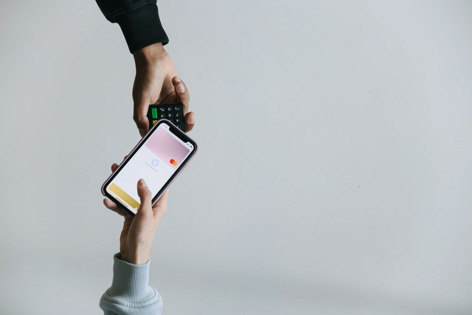 Hands making a payment on a smartphone